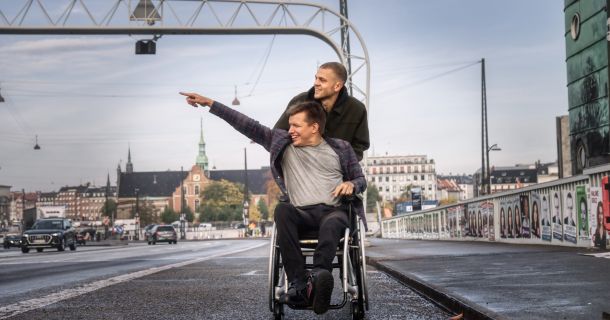 Young disabled man and his caregivers enjoying life