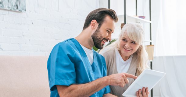 Caregiver and resident looking at digital solution